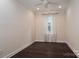 This bedroom has neutral colored walls and dark hardwood floors at 286 Hemlock Bluff Ct, Denver, NC 28037