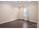 This bedroom has neutral colored walls and dark hardwood floors at 286 Hemlock Bluff Ct, Denver, NC 28037