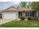 Charming single-story home featuring brick and vinyl siding, an attached garage and manicured front yard at 286 Hemlock Bluff Ct, Denver, NC 28037
