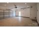 Spacious two-car garage with high ceilings, epoxy flooring, and ample storage space at 286 Hemlock Bluff Ct, Denver, NC 28037