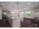 Open-concept kitchen featuring a large island, stainless steel appliances, and access to the living area at 286 Hemlock Bluff Ct, Denver, NC 28037