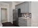 Well-equipped kitchen with stainless steel refrigerator, granite countertops, and custom cabinetry at 286 Hemlock Bluff Ct, Denver, NC 28037