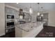 Modern kitchen with stainless steel appliances, granite countertops, and gray cabinetry at 286 Hemlock Bluff Ct, Denver, NC 28037