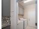 This laundry room features gray cabinets, mosaic backsplash, and tile floors at 286 Hemlock Bluff Ct, Denver, NC 28037