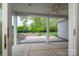 Covered patio featuring stone firepit, lush landscaping and backyard views at 286 Hemlock Bluff Ct, Denver, NC 28037