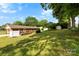 A spacious backyard includes a fenced-in garden and mature trees at 300 Scotland Dr, Kings Mountain, NC 28086