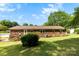 The backyard has a wooden deck and shade trees at 300 Scotland Dr, Kings Mountain, NC 28086