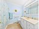 Bright blue bathroom with white vanity, neutral flooring, and shower/tub combination at 300 Scotland Dr, Kings Mountain, NC 28086