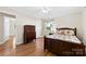 The wooden bed frame and hardwood floors give this bedroom a warm feeling at 300 Scotland Dr, Kings Mountain, NC 28086