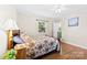 Bright bedroom features a wooden bed frame, wood floors, and a view to the backyard at 300 Scotland Dr, Kings Mountain, NC 28086