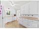 Well-lit kitchen with white cabinets, modern appliances, and neutral countertops at 300 Scotland Dr, Kings Mountain, NC 28086