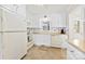 Bright kitchen featuring white cabinets, neutral countertops, and vinyl flooring at 300 Scotland Dr, Kings Mountain, NC 28086