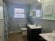 Well-lit bathroom featuring wainscotting, a white sink, and a decorative mirror at 3100 Wallace Rd, Midland, NC 28107