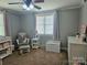 Comfortable Bedroom with a plush glider, changing station and a window with natural light at 3100 Wallace Rd, Midland, NC 28107