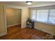 Bright bedroom featuring hardwood floors and large windows, offering a warm, inviting atmosphere at 3100 Wallace Rd, Midland, NC 28107