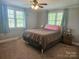 Cozy bedroom with two windows providing natural light and a ceiling fan for added comfort at 3100 Wallace Rd, Midland, NC 28107