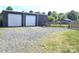Detached garage with multiple bays and gravel driveway at 3100 Wallace Rd, Midland, NC 28107