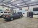 Spacious garage featuring vehicles, ample storage, a refrigerator, and 'Michael's Personal Cave' sign at 3100 Wallace Rd, Midland, NC 28107