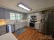 Kitchen featuring stainless steel appliances, gray cabinets, and hardwood floors at 3100 Wallace Rd, Midland, NC 28107