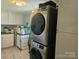 Functional laundry room featuring a modern, stacked washer and dryer unit and ample cabinet space at 3100 Wallace Rd, Midland, NC 28107