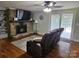 Comfortable living room features a stone fireplace, hardwood floors, and natural light from sliding glass doors at 3100 Wallace Rd, Midland, NC 28107