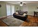 Cozy living room with hardwood floors, a ceiling fan, and access to the outdoor patio at 3100 Wallace Rd, Midland, NC 28107