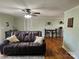 Cozy Gathering room featuring hardwood floors, ceiling fan and a comfortable leather couch at 3100 Wallace Rd, Midland, NC 28107