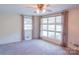 Bright and airy bedroom featuring large windows, neutral carpet, and a ceiling fan at 3119 6Th Sw Ave, Hickory, NC 28602