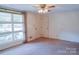 Cozy bedroom with large windows, neutral walls, and a ceiling fan, offering a comfortable living space at 3119 6Th Sw Ave, Hickory, NC 28602