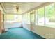 A screened porch with a white ceiling, carpet and brick flooring. Plenty of natural light streams through at 3119 6Th Sw Ave, Hickory, NC 28602