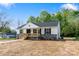 Charming exterior view showcasing the front porch, gray stone accents, and well-manicured landscaping at 3315 15Th Sw Ave, Hickory, NC 28602