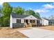 Charming exterior view showcasing the front porch, gray stone accents, and well-manicured landscaping at 3315 15Th Sw Ave, Hickory, NC 28602