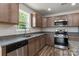 A kitchen featuring stainless steel appliances, granite counters, wood cabinets, and wood flooring at 3315 15Th Sw Ave, Hickory, NC 28602