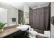 Well-lit bathroom boasts a vanity, toilet, shower-tub combo with stylish finishes at 333 W Trade St # 800, Charlotte, NC 28202