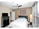 Neutral bedroom featuring a ceiling fan, unique wall art, and a window providing natural light at 333 W Trade St # 800, Charlotte, NC 28202