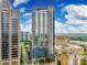 Modern high rise building with glass windows, balconies, and surrounding city views on a sunny day at 333 W Trade St # 800, Charlotte, NC 28202