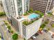 A rooftop pool surrounded by lounge chairs and greenery sits atop a building with parking at 333 W Trade St # 800, Charlotte, NC 28202