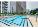 Sparkling outdoor swimming pool surrounded by lounge chairs, greenery, and modern buildings at 333 W Trade St # 800, Charlotte, NC 28202