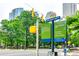 Street view of Uptown West directional sign surrounded by city buildings and lush green trees at 333 W Trade St # 800, Charlotte, NC 28202