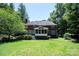 Expansive backyard showcases a brick home, screened porch, and lush green lawn at 3546 Weddington Oaks Dr, Weddington, NC 28104