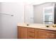 Spacious bathroom featuring a double sink vanity with wood cabinets and a large mirror at 3546 Weddington Oaks Dr, Weddington, NC 28104