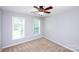 Simple bedroom with carpet floors, a ceiling fan, and two windows at 3546 Weddington Oaks Dr, Weddington, NC 28104