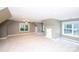 Expansive bonus room with neutral carpet, ample natural light, and unique architectural details at 3546 Weddington Oaks Dr, Weddington, NC 28104