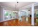 Dining room with hardwood floors, a chandelier, and large windows with natural light at 3546 Weddington Oaks Dr, Weddington, NC 28104