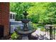 Backyard multi-tiered fountain adding charm and elegance to the outdoor space at 3546 Weddington Oaks Dr, Weddington, NC 28104