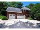 Large three car garage with spacious driveway, beautiful brick, and green landscaping at 3546 Weddington Oaks Dr, Weddington, NC 28104