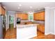 Well-equipped kitchen with granite counters, stainless steel appliances, wood cabinetry, and hardwood floors at 3546 Weddington Oaks Dr, Weddington, NC 28104