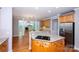 Bright kitchen with granite counters, a stainless steel refrigerator, and hardwood floors at 3546 Weddington Oaks Dr, Weddington, NC 28104