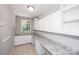 Functional laundry room with granite countertops, ample storage, and a window at 3546 Weddington Oaks Dr, Weddington, NC 28104