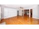 Open living room with hardwood floors, a built in bookcase, and access to the kitchen at 3546 Weddington Oaks Dr, Weddington, NC 28104